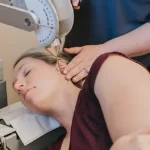 A women bring treated for Atlas Orthogonal pain.