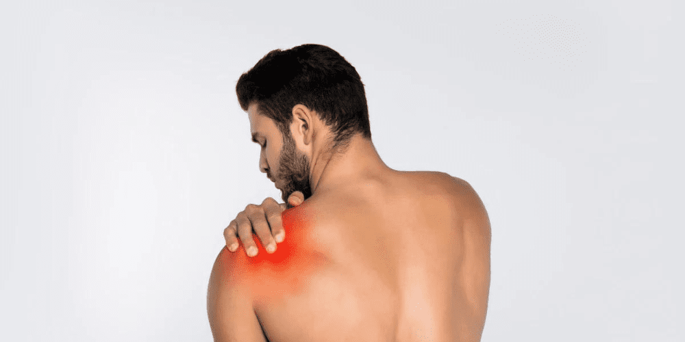 A Man having pain and holding his shoulder