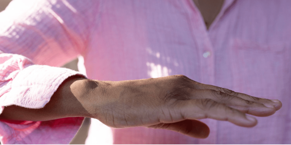 A women's hand shaking.