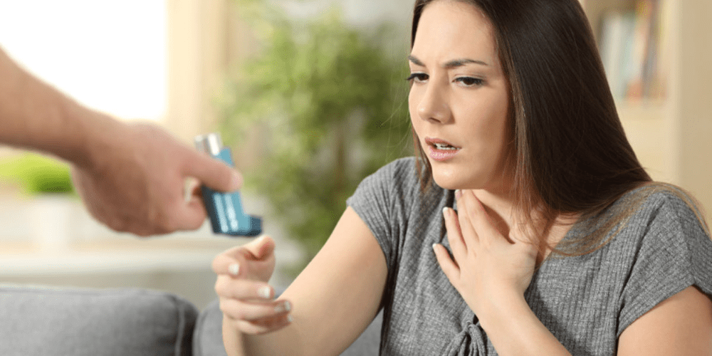 A women being given an inhaler.