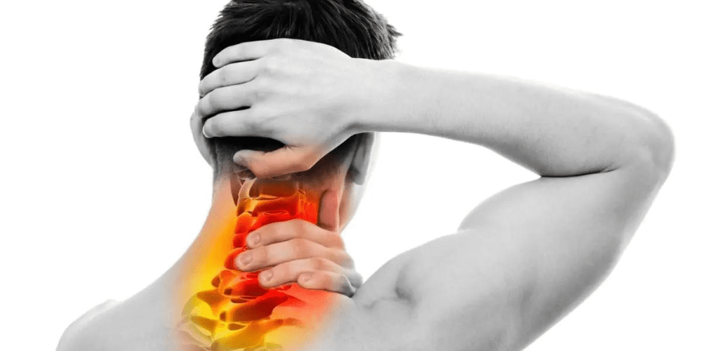 A man holding his neck.
