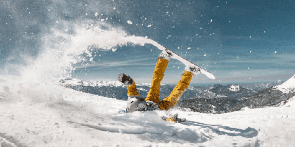 A winter rider falling on his neck and back.